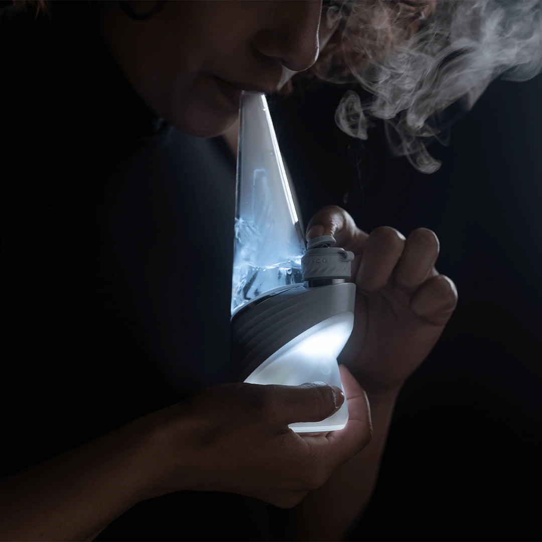 User enjoying Puffco New Peak Pro Pearl smart rig with smooth water filtration and ergonomic joystick cap